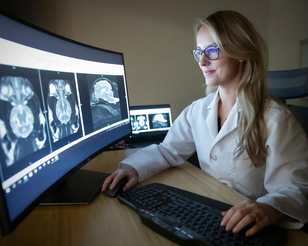 Lady Radiologist sitting in front of her screen and reading case study